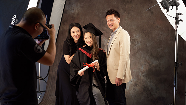 Fresh graduate taking pictures with family